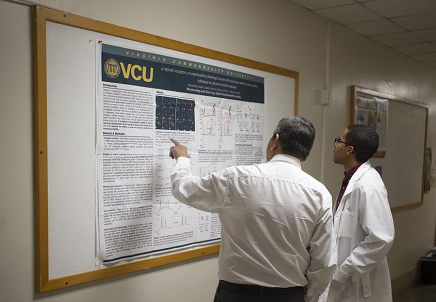 Dr. Akbarali and Stanley Cheatham examining poster